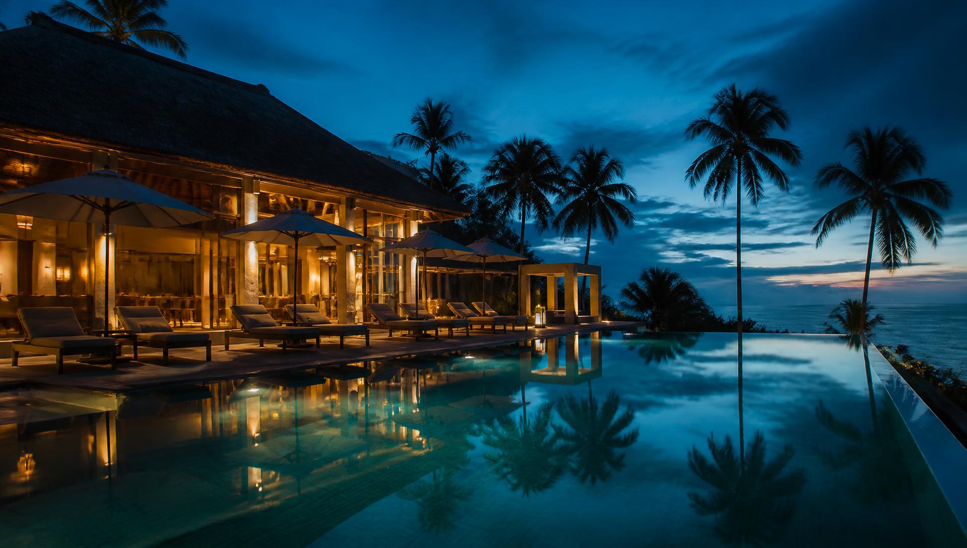 Resort at dusk with an infinity pool overlooking the ocean